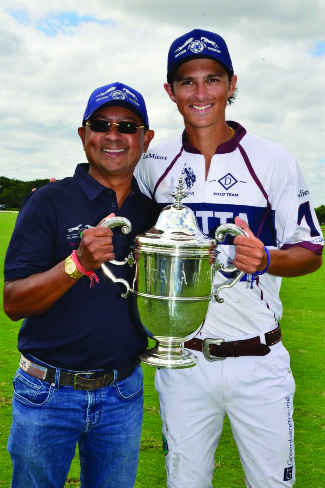 Tim Dutta and Timmy Dutta holding a polo trophy